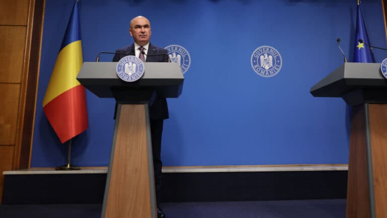 Ilie Bolojan explică rațiunile din spatele creșterii TVA, în ciuda opoziției lui Nicușor Dan: responsabilitatea guvernului este esențială.